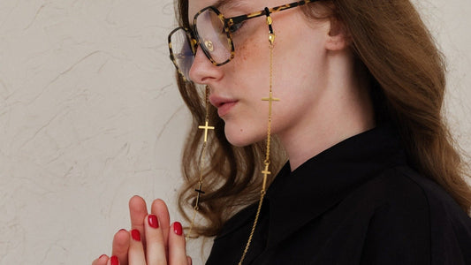 A woman wearing a gold glasses chain.