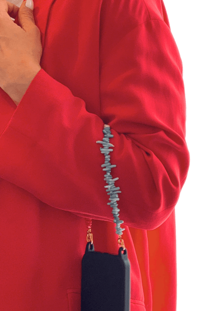 Model holding a smartphone with the Bay Play Summer Gemstone Phone Strap, showcasing the vibrant beads