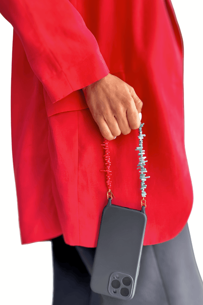 Model holding a smartphone with the Bay Play Summer Gemstone Phone Strap, showcasing its distinct design.