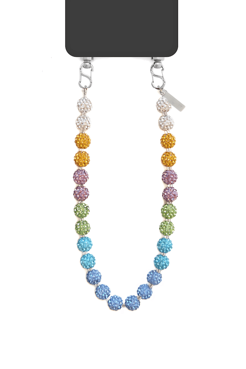 Phone resting on a surface with the strap draped around it.