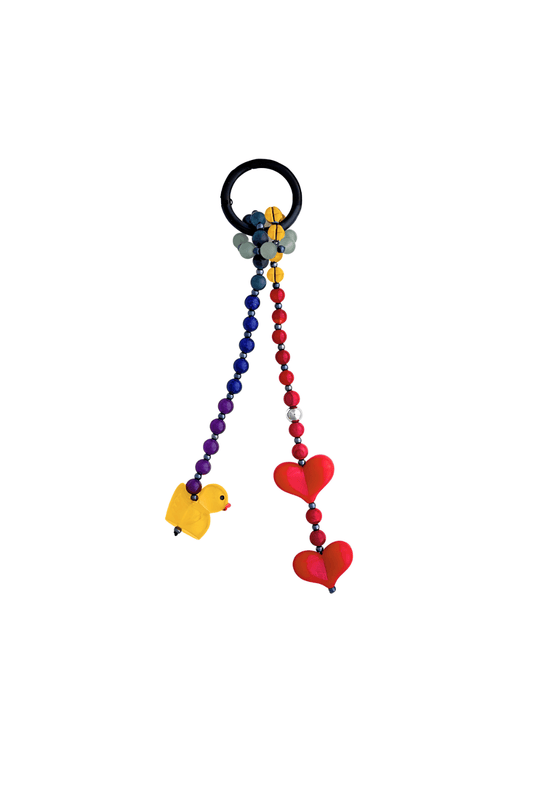 Close-up of beaded purse charm with red hearts and duck with a black keyring.
