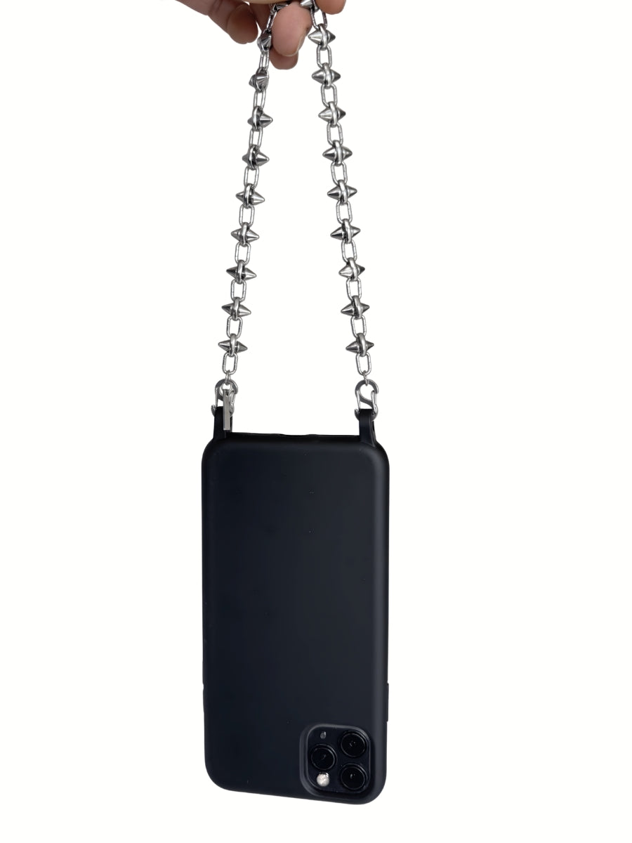 Black phone case with the FINE CUT silver phone chain held by a hand on a white background.