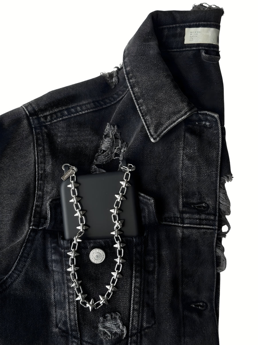 Black jean jacket with a black phone case and FINE CUT phone chain attached.