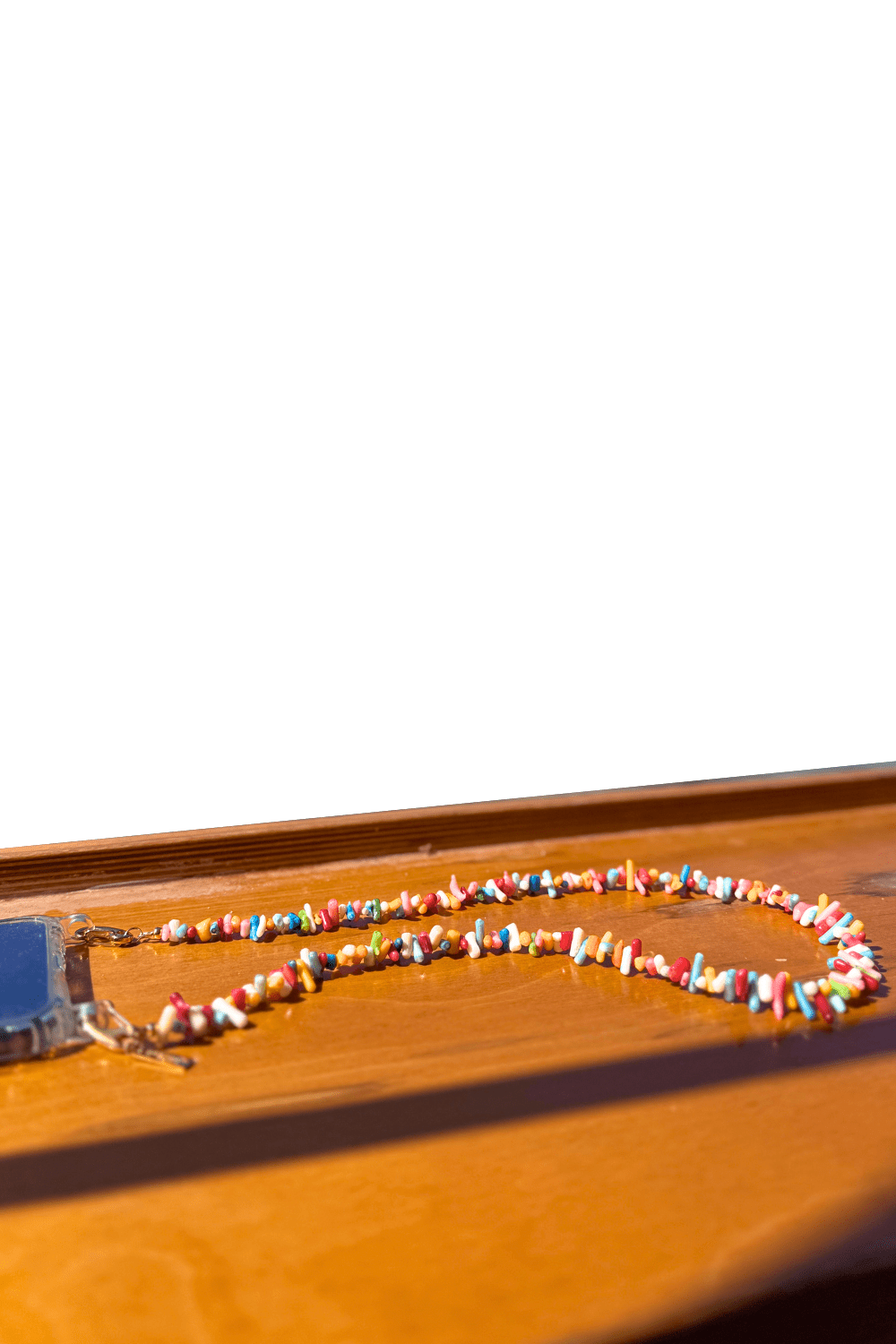 SPECSET Free Spirit Phone Necklace, showcasing the colorful array of genuine gemstone chips on a white background.