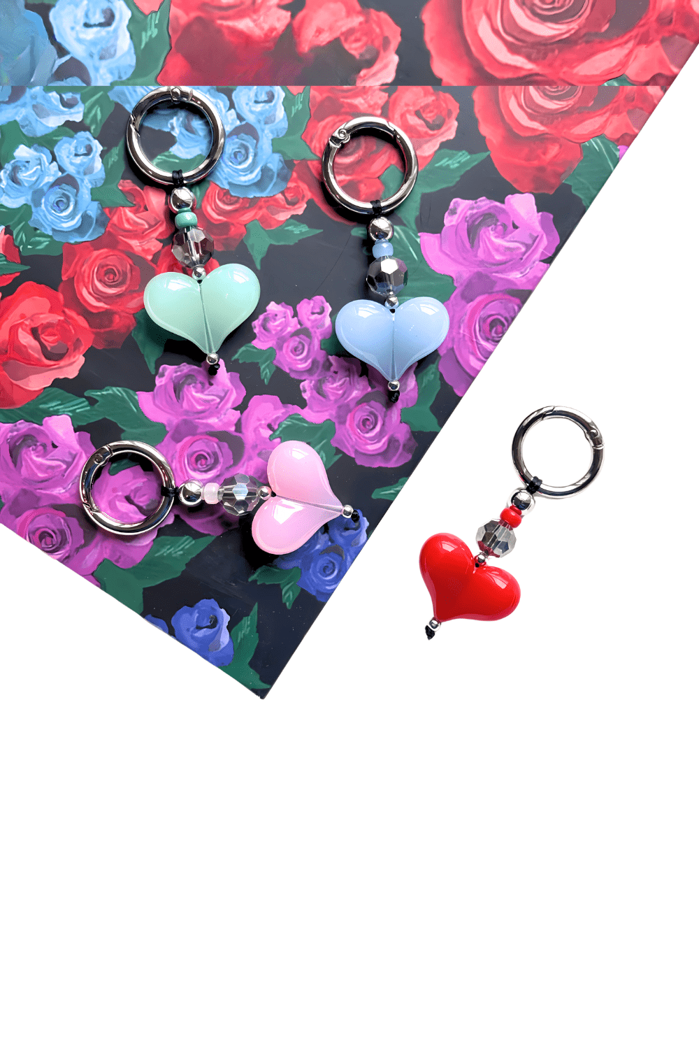 Heart-shaped keychains on a floral background