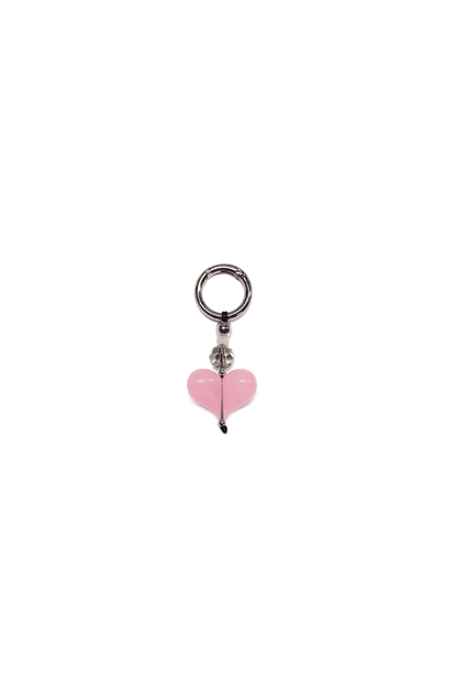 Pink heart-shaped charm on a white background