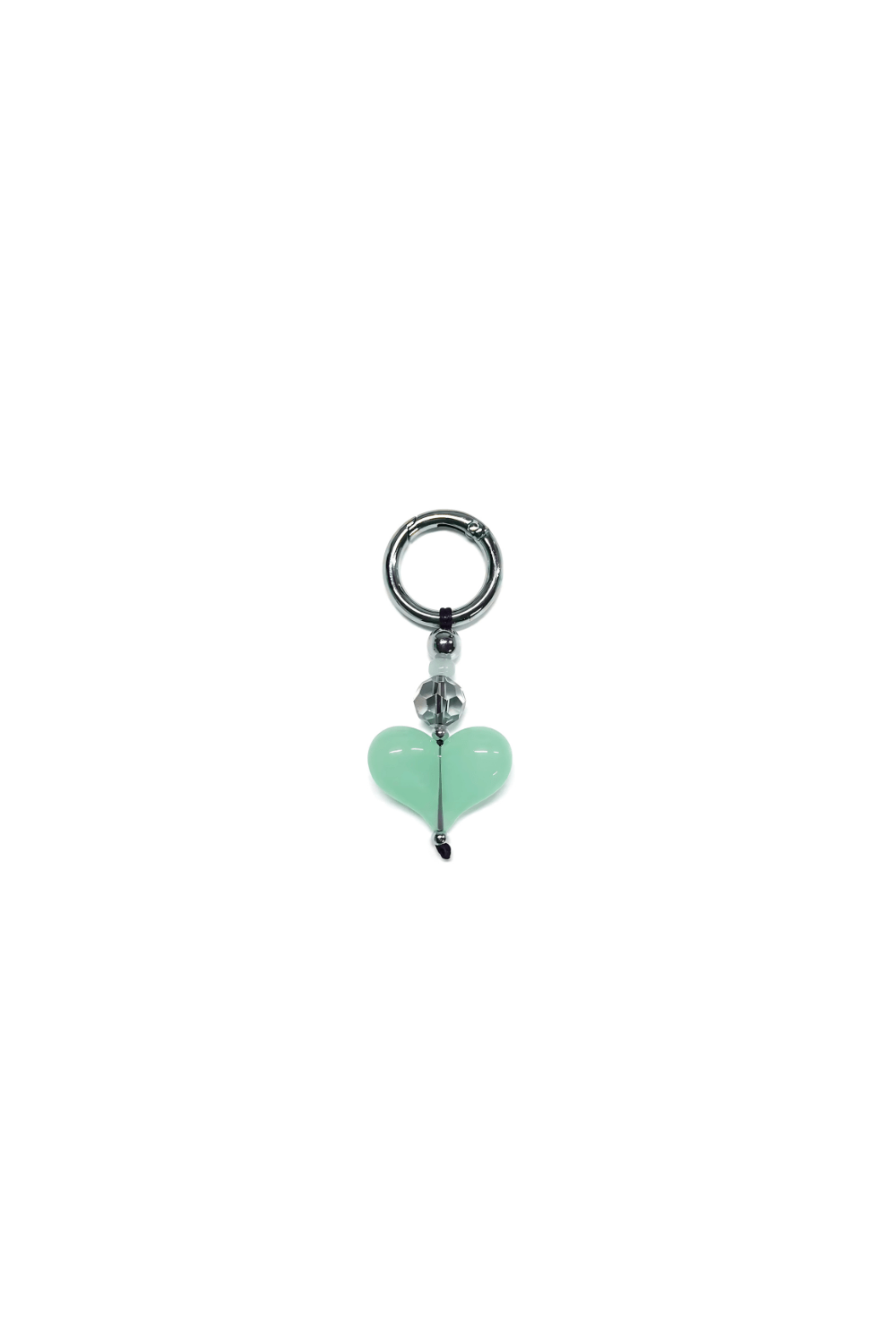 Jewelry charm with a heart-shaped green gem on a white background