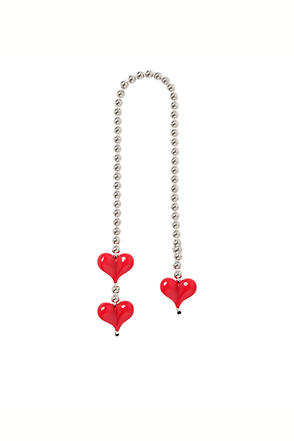 Silver beaded bag charm with red hearts on a white background.