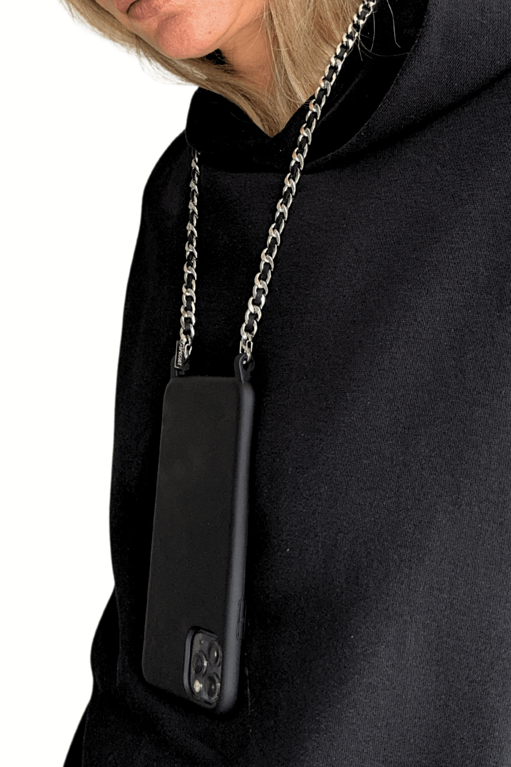 Woman wearing a black hoodie with a phone case attached to the Iconic Phone Chain.