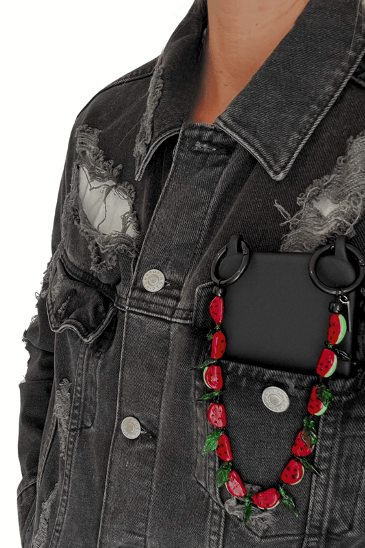 Juicy Crush strap attached to a black phone case.