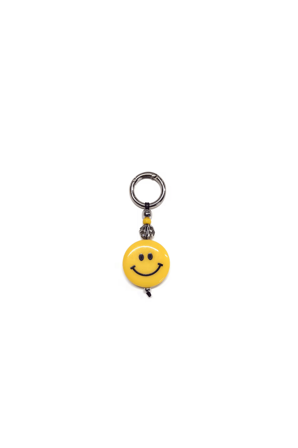 Yellow smiley face charm on a white background