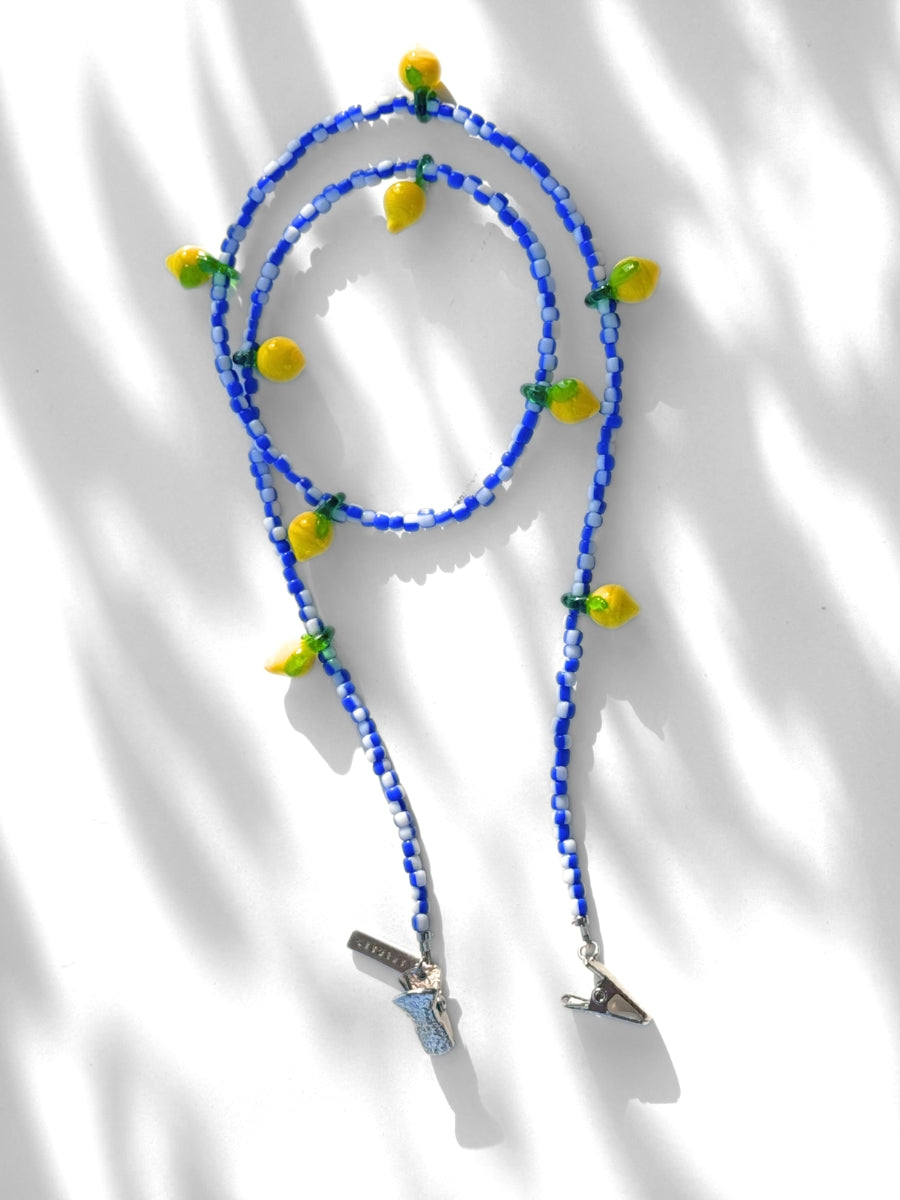 Blue beaded eyewear chain with lemon charms and silver clip ends.