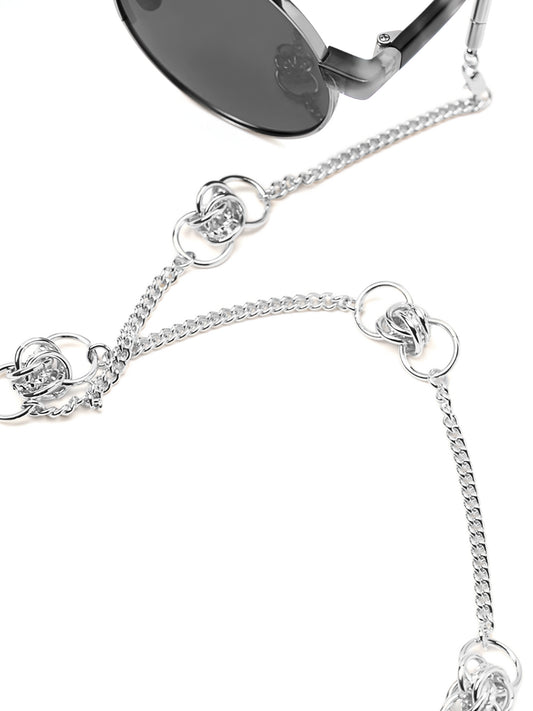 Silver eyewear chain with mixed-size round elements worn with sunglasses