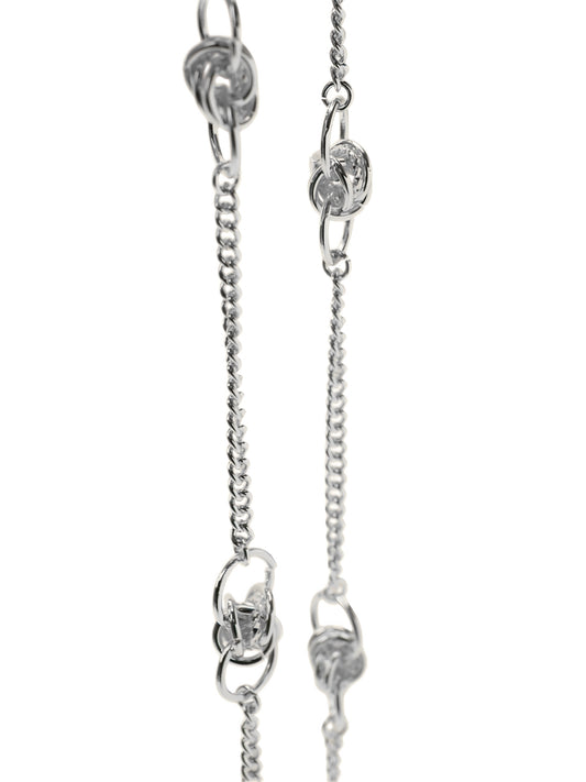 Silver eyewear chain with mixed-size round details from surgical stainless on white background.