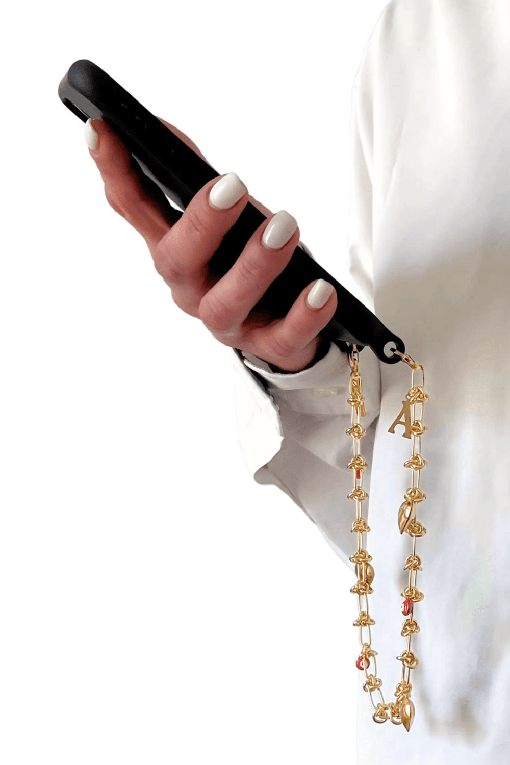 Woman holding a phone, wearing the Lover's Link gold chain chain, showcasing the length and design.