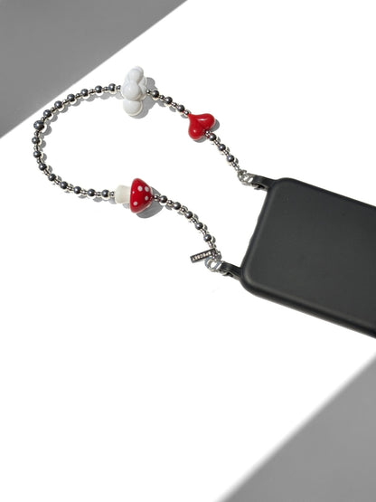 A black smartphone case attached to a silver beaded chain strap with white and red mushroom-shaped charms, shown on a white background with gray shadows.