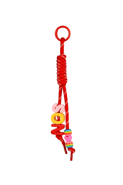Red bag charm keychain with colorful beads on a white background.