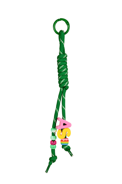 Green bag charm keychain with colorful beads on a white background.