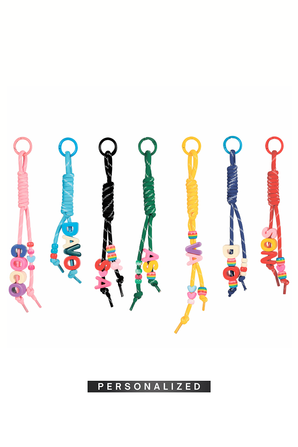 Set of colorful personalized bag keychains on a white background