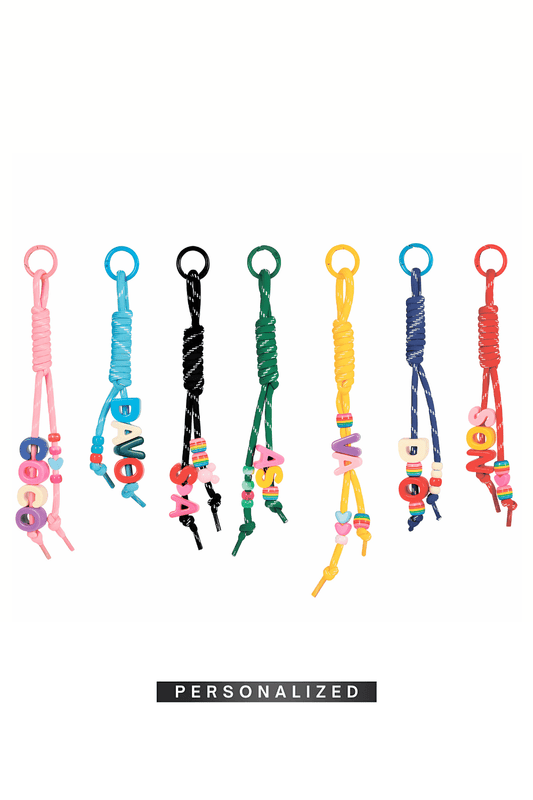 Set of colorful personalized bag keychains on a white background