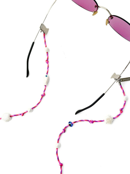 Pink and purple braided sunglasses strap with white beads, shown with sunglasses on a white background.
