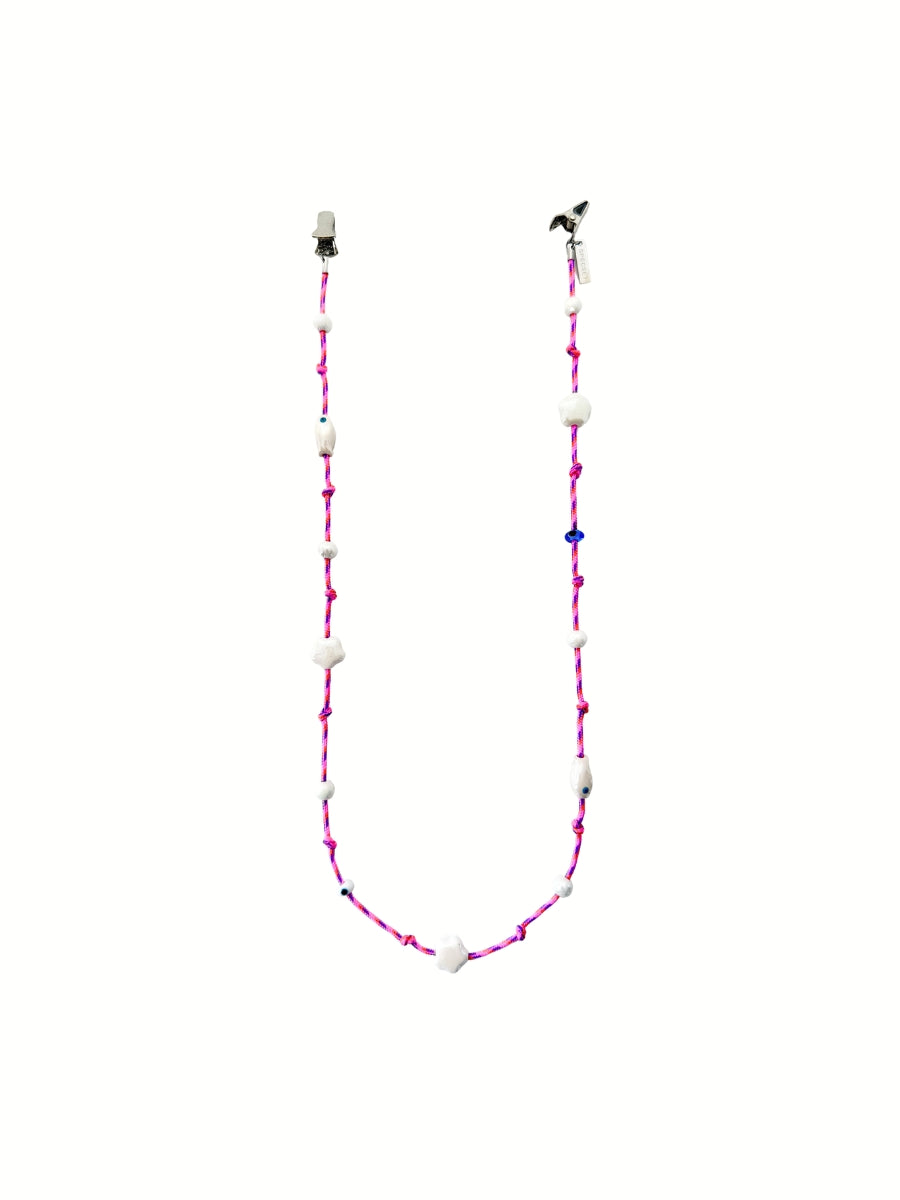 A beaded eyewear  featuring white ceramic beads, fishes, and evil eye details, displayed against a white background.
