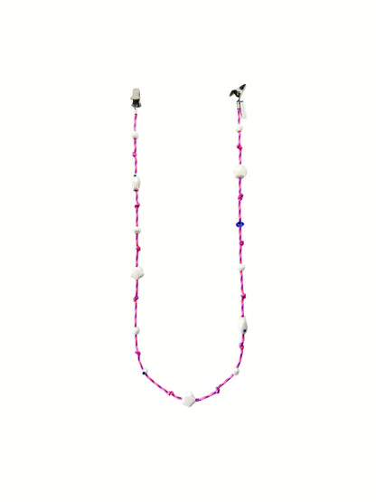 A beaded eyewear  featuring white ceramic beads, fishes, and evil eye details, displayed against a white background.