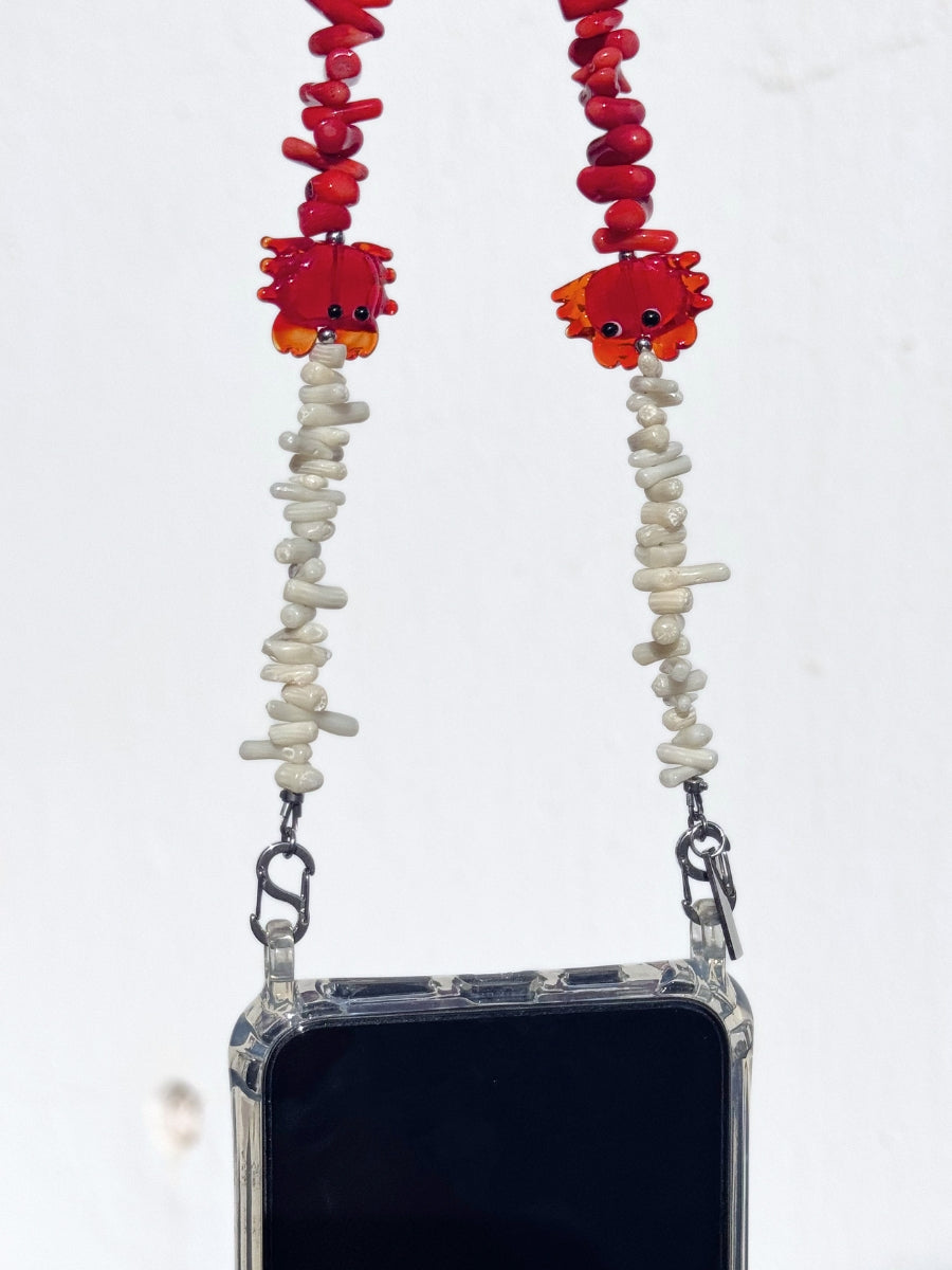 Close-up of natural gemstone chips with playful crab and lobster charms