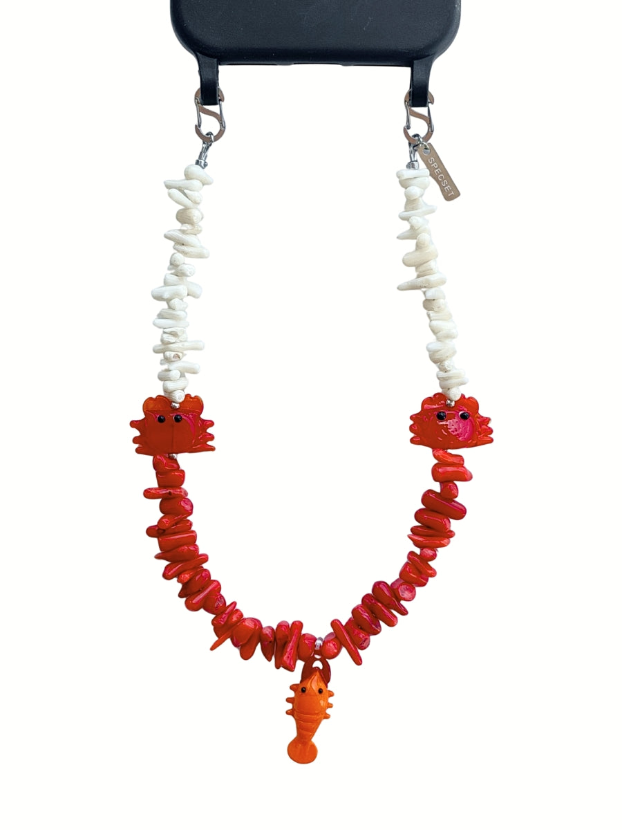 Handmade gemstone phone strap with red and white gemstone chips, crab charms and lobster charm