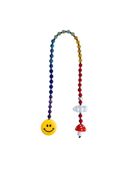 Rainbow beaded bag charm with smiley face, mushroom, and cloud charms on white background.