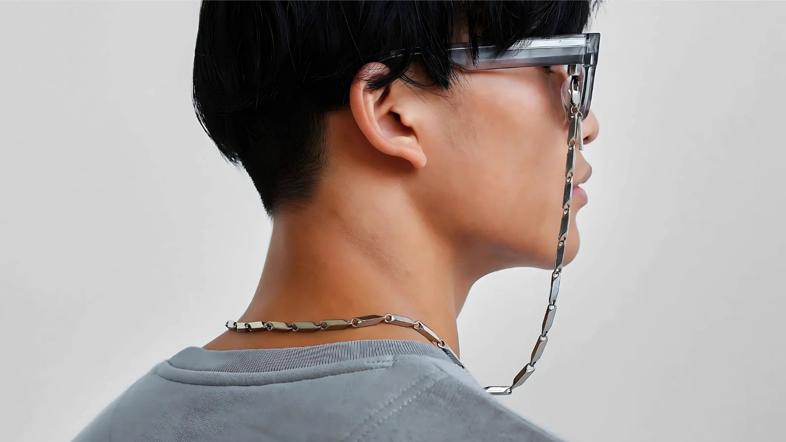 Model wearing silver geometric eyewear chain by SPECSET — minimalist eyewear accessory.