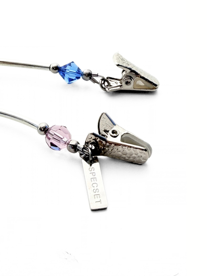 Detail of the stainless steel hardware with clip ends and logo tag on the SOCIALITE eyewear strap.