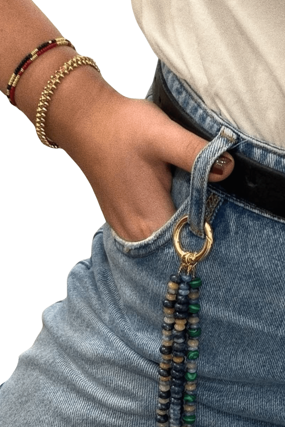 Close-up of the Stone Drop Tassel Charm clipped to a jeans belt loop, showing its unique use as a Pants Pendant accessory.