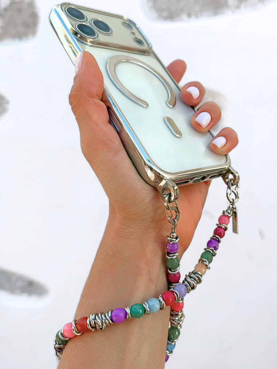 Tropic Tones colorful gemstone strap wrapped around wrist holding a smartphone case.