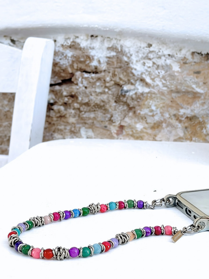 Close-up of Tropic Tones phone chain featuring vibrant gemstones and stainless steel ring details.