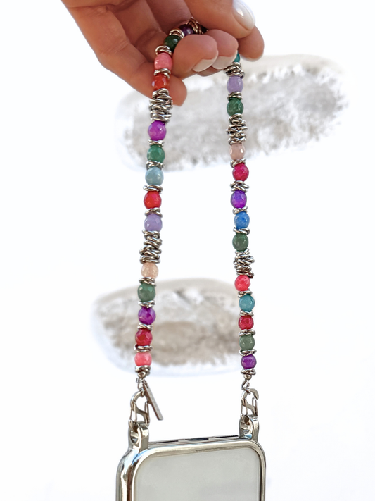 Hand holding Tropic Tones gemstone phone chain showing its 35cm length and stainless steel double clasps.